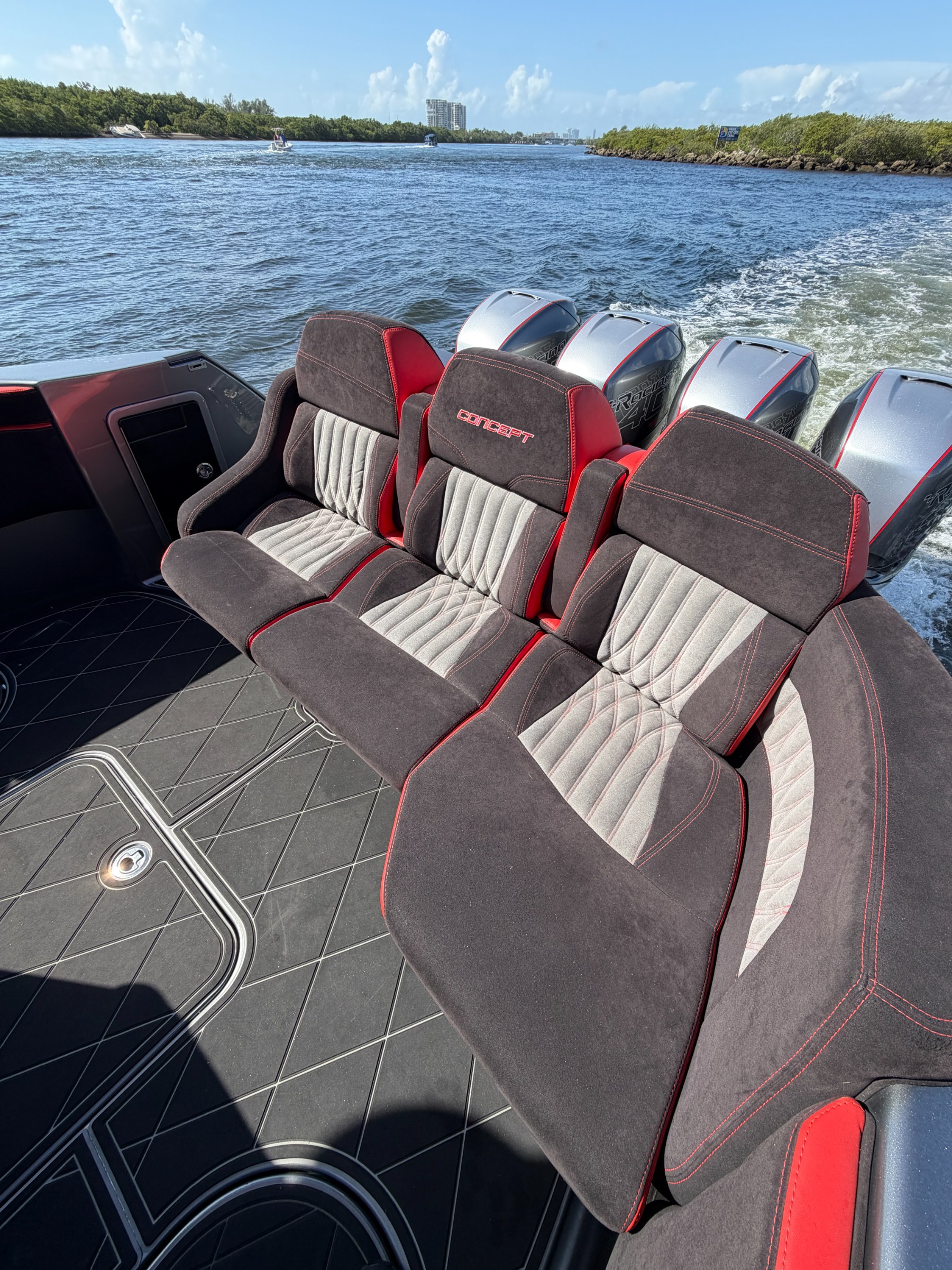 Sculpted suede bucket seating in the Lucky 13 cockpit underway, quad outboards behind