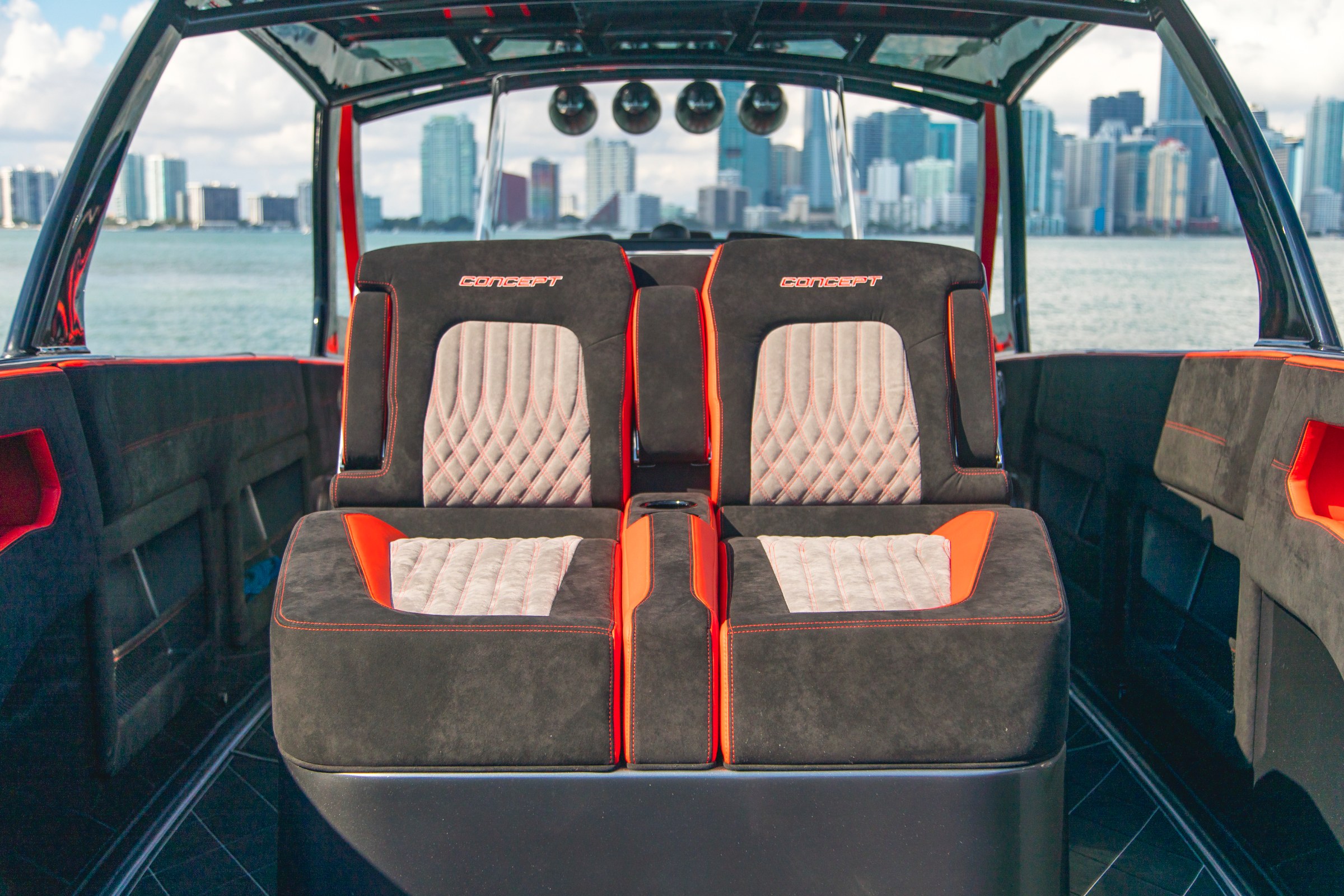 Lucky 13 suede cockpit seating with diamond stitching, Miami skyline beyond