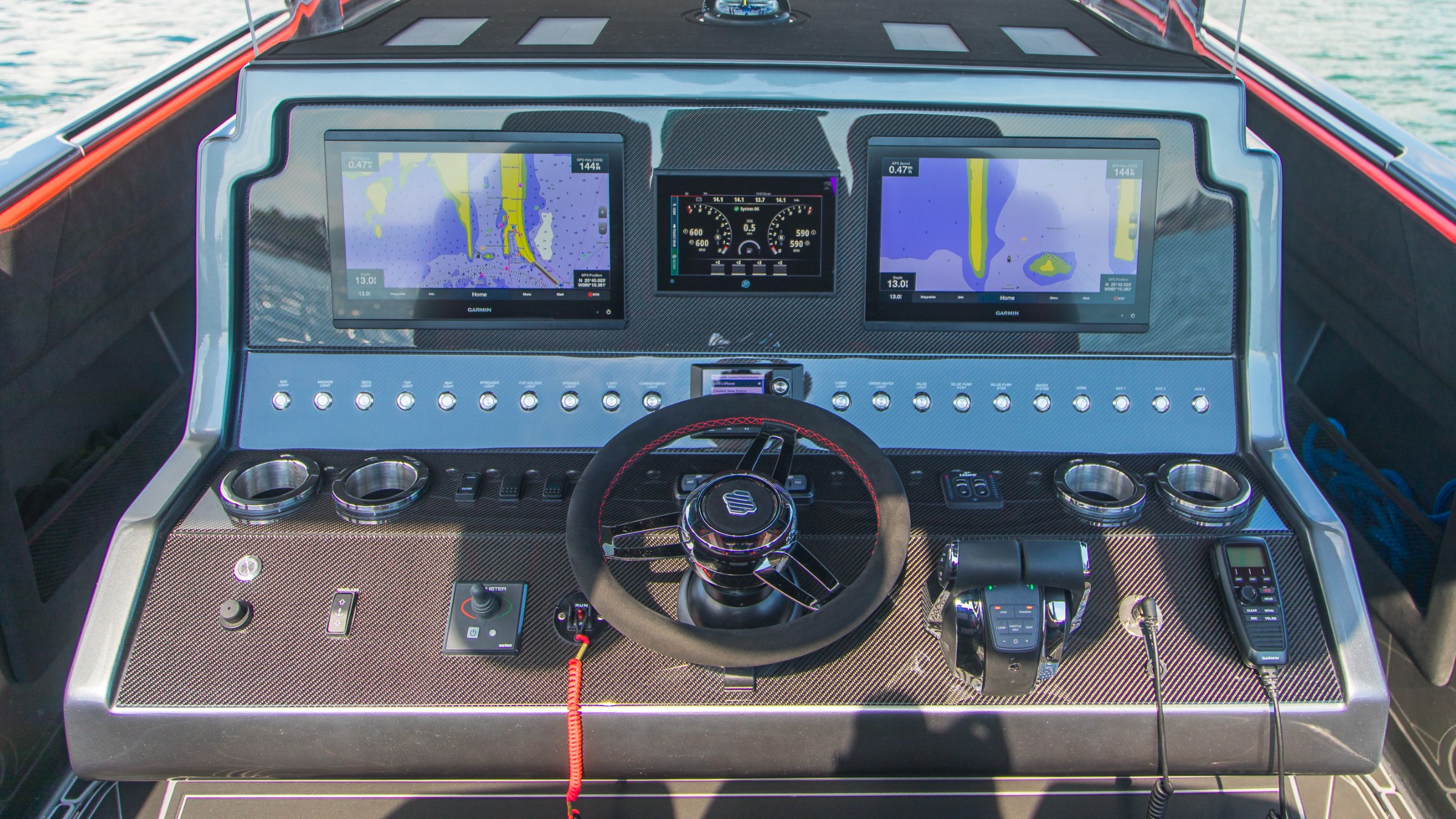 Lucky 13 carbon fiber helm with dual Garmin GPSMAP 8616 displays and suede-wrapped wheel