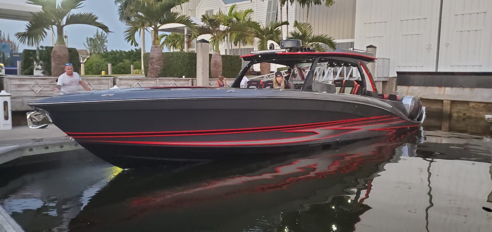 Lucky 13 full profile on the water, custom grey Concept 4400 with red accent striping