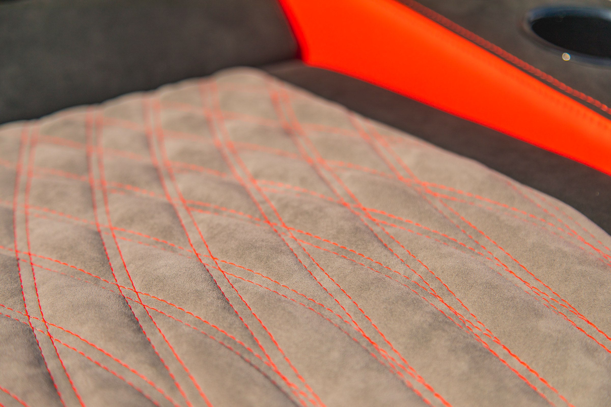 Diamond-stitched suede seating detail with red contrast thread aboard Lucky 13